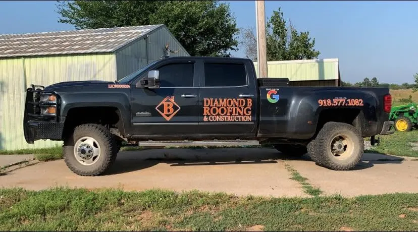 The black Diamond B Roofing and Construction dually truck with orange lettering